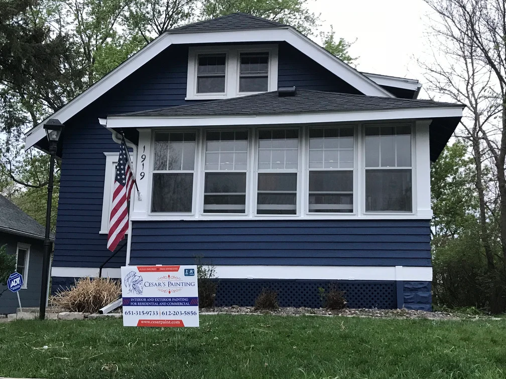 Dark blue and white exterior house paint on residential home with horizontal siding