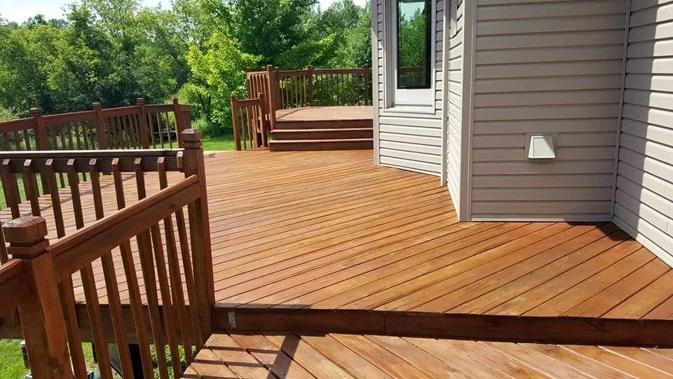 Multi-level cedar-stained deck with wooden railings and composite decking boards