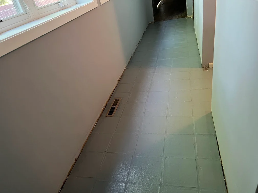 Hallway with freshly primed drywall and prepared walls for painting