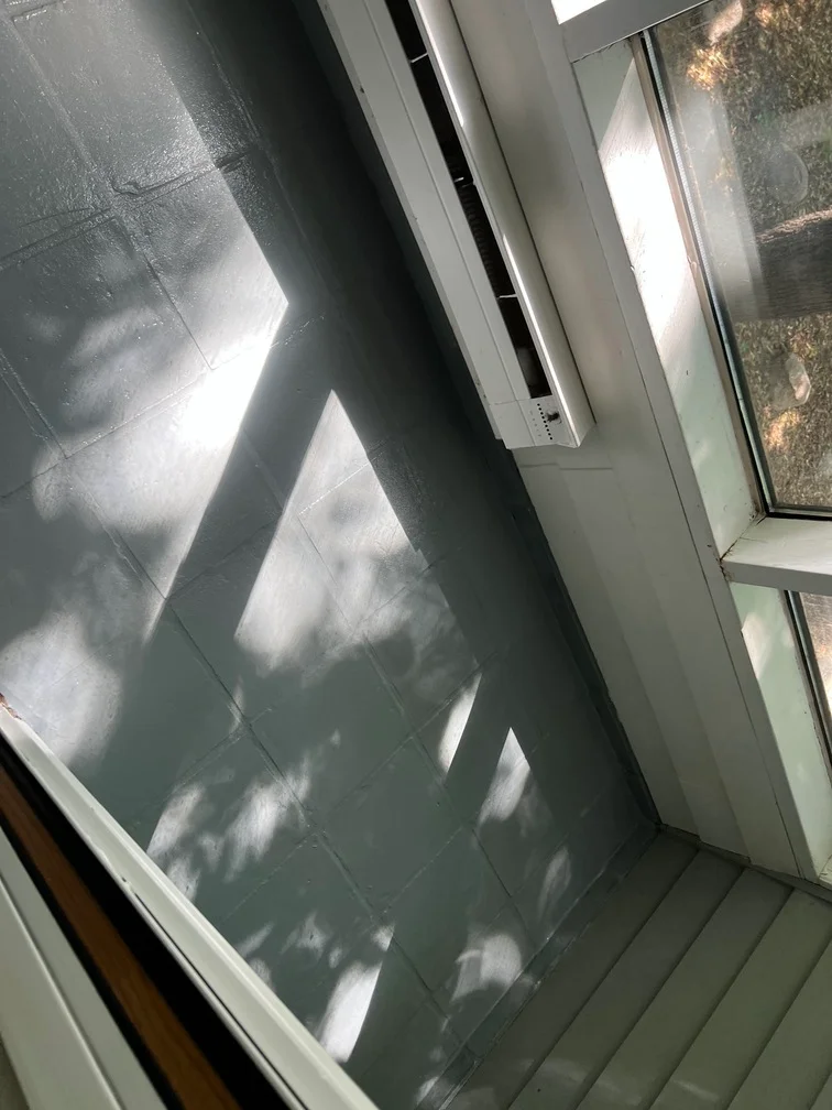 Interior drywall and trim painted in gray-green with white trim, natural light showing even finish
