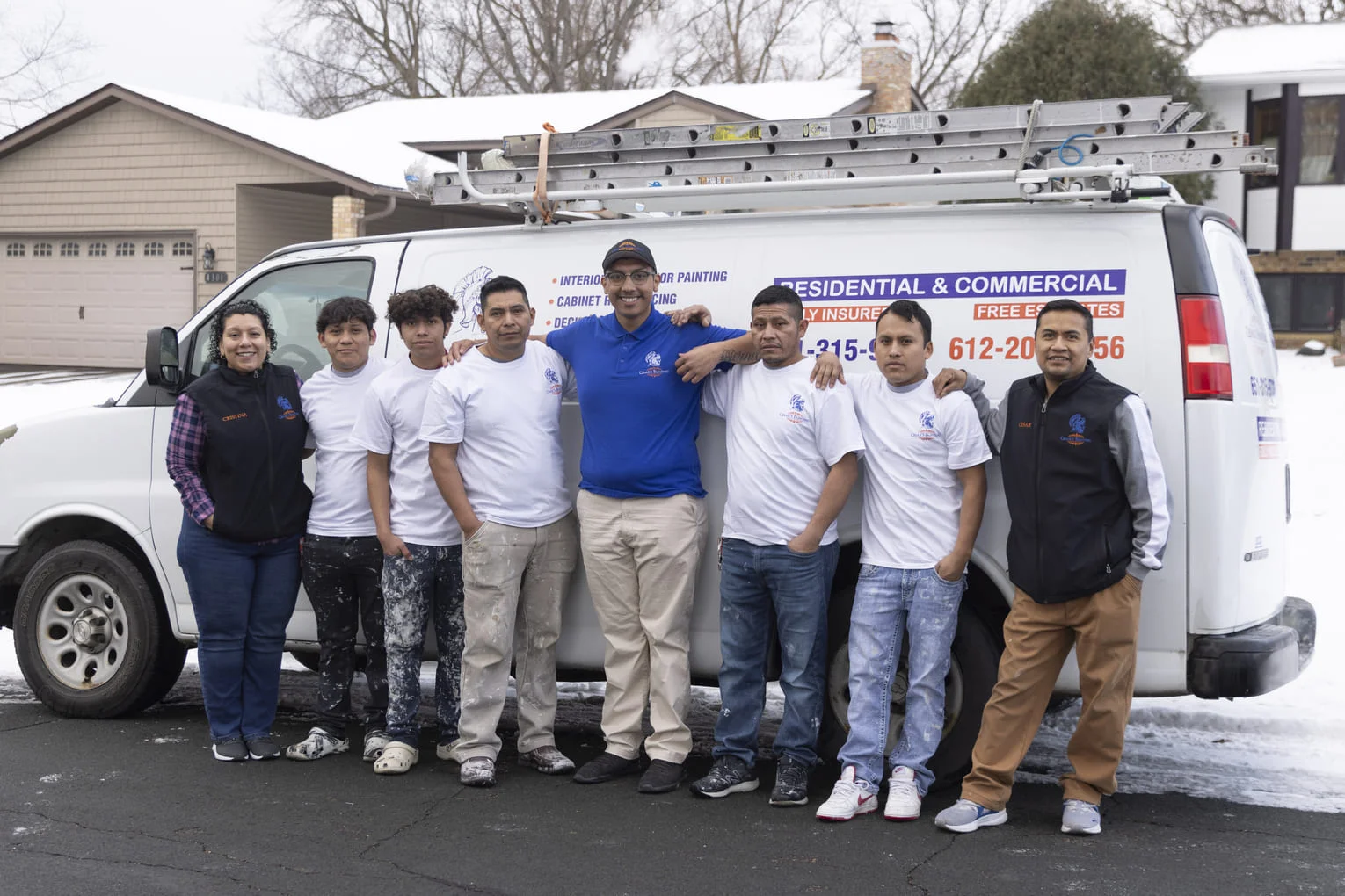 Painting crew team with service van equipped with ladder rack and professional equipment
