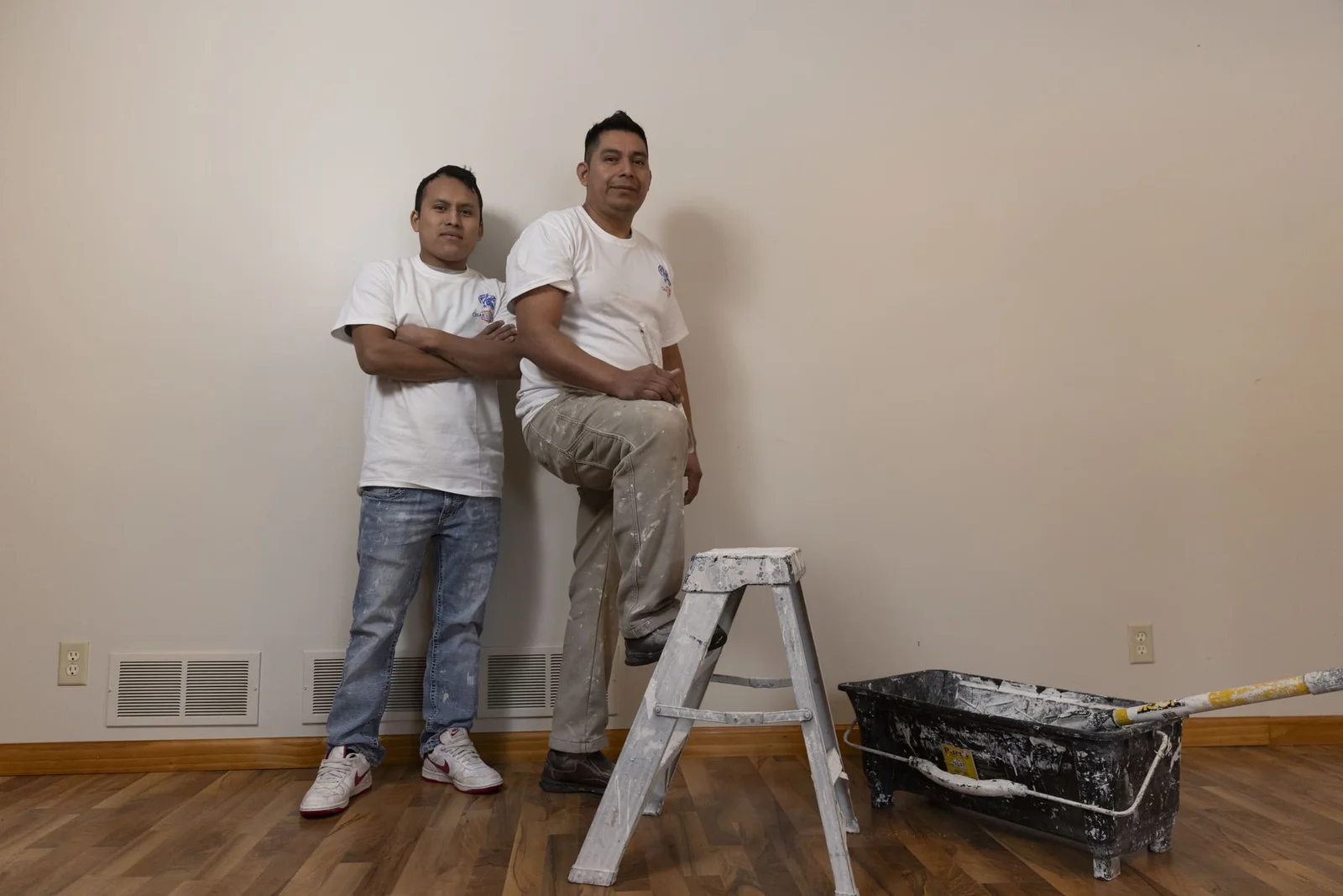 Interior wall painting with fresh paint application on drywall and baseboards