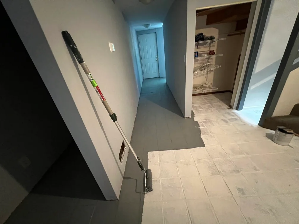 Interior hallway with freshly painted white drywall walls, trim, and closet space