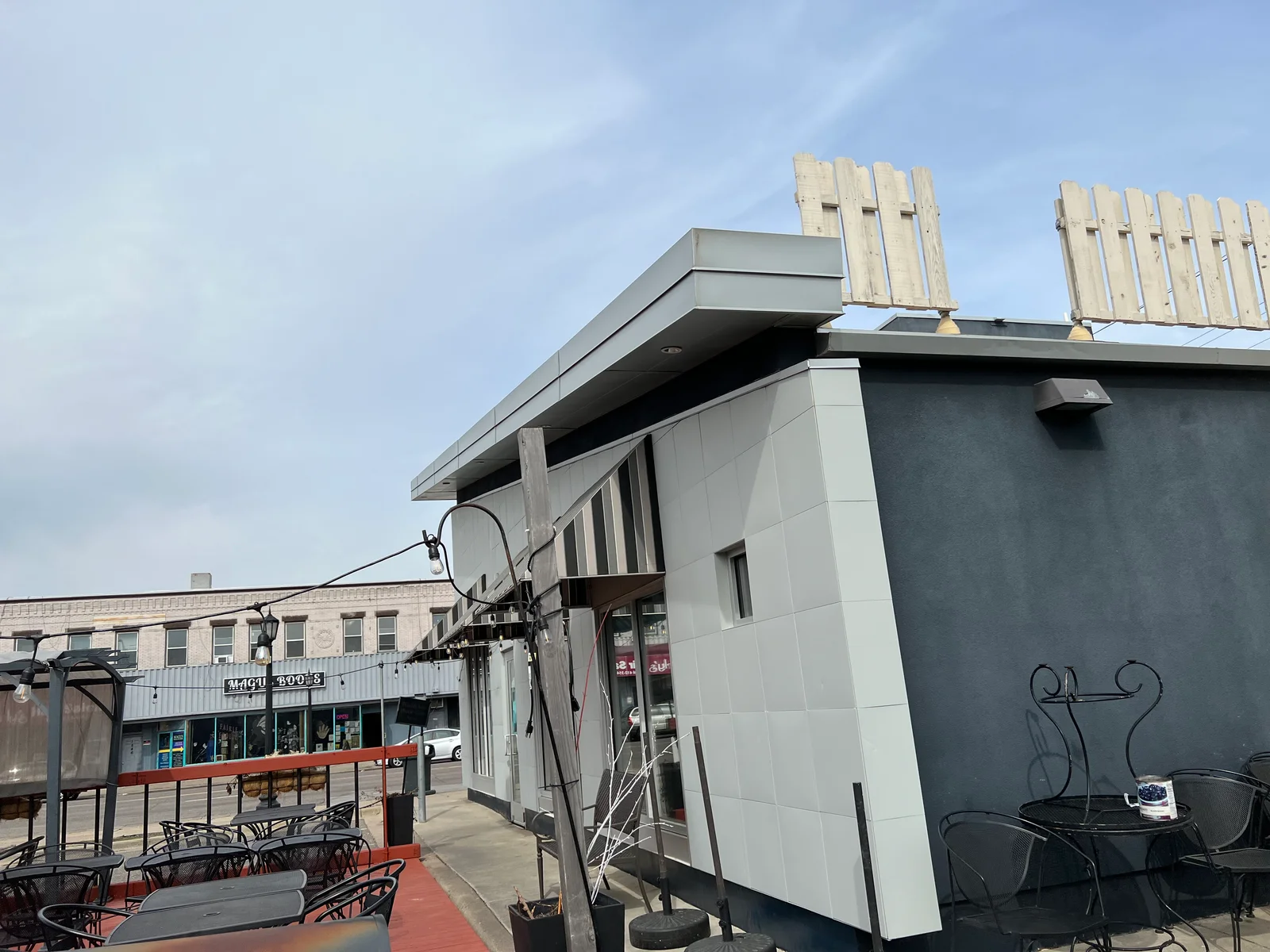 Gray and white painted commercial building exterior with composite panels and trim work