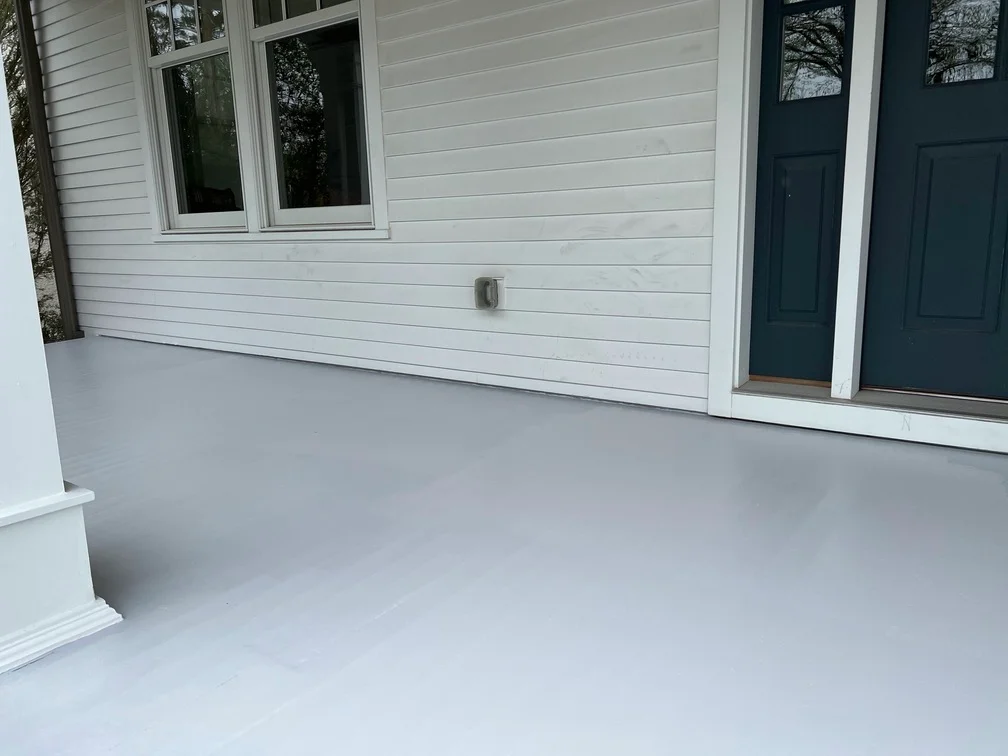 White painted horizontal siding, window frames, and door trim on residential exterior